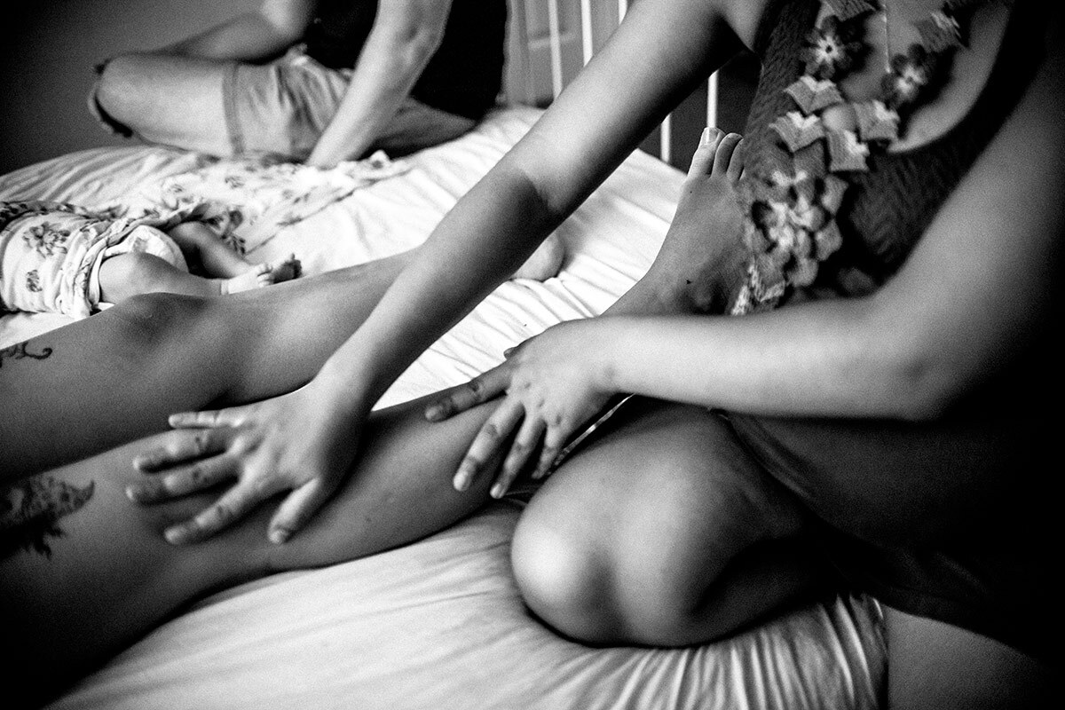 Panquetzani massages the legs of new mother Kat Cardenas. | Samanta Helou Hernandez