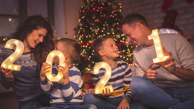 A family holds numbers counting down to the New Year.