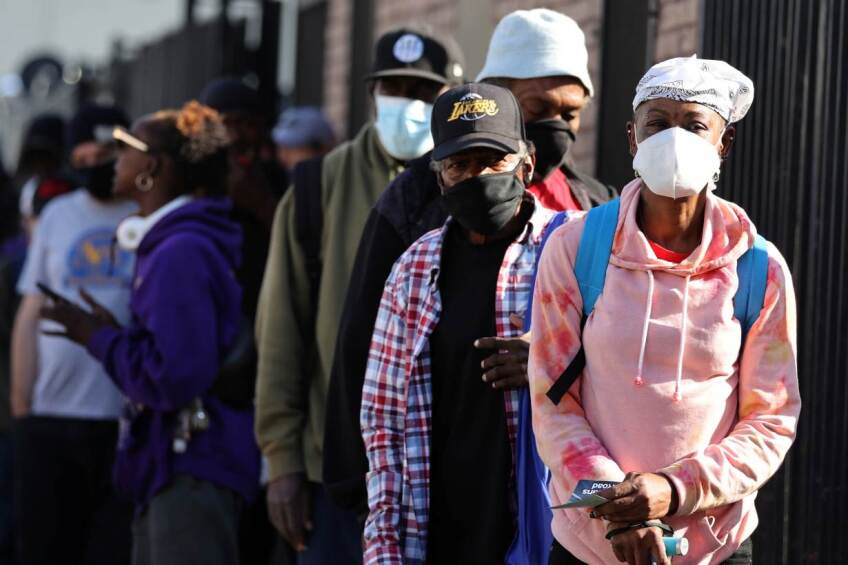 People wait in line for a Los Angeles Mission homeless shelter Thanksgiving meal giveaway, as the global outbreak of the coronavirus disease (COVID-19) continues, in Los Angeles, California, U.S., November 25, 2020. 