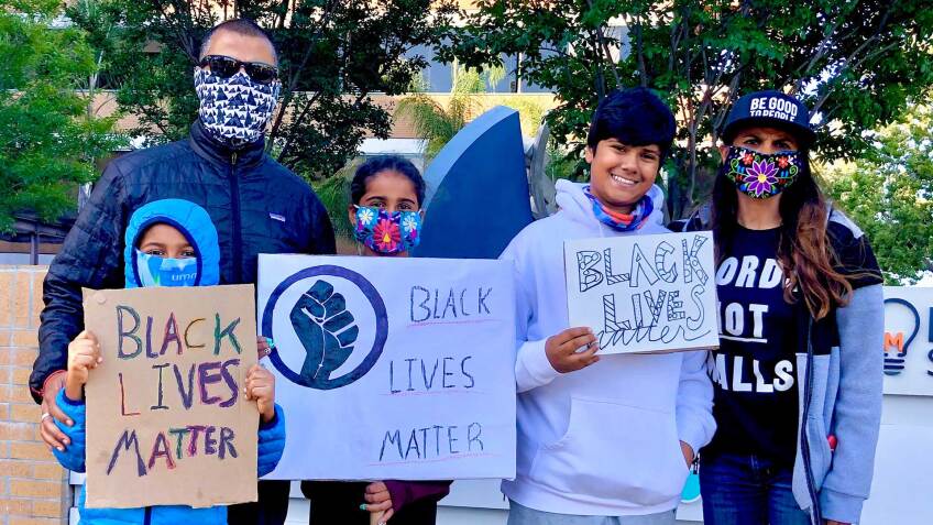 Aila Malik’s family holds Black Lives Matter posters at a demonstration