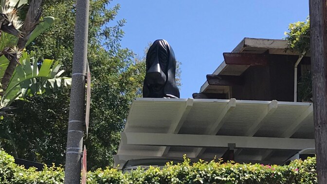 Jason Yates’ sad droopy dog sculpture on a rooftop in East Hollywood. | Carol Cheh
