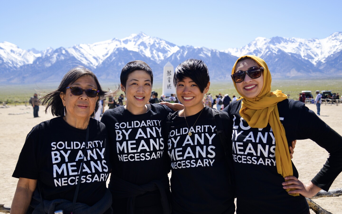 Vigilant Love community members Kathy Masaoka, traci kato-kiriyama, traci ishigo, Sahar Pirzada pose together for a photo at a solidarity rally.
