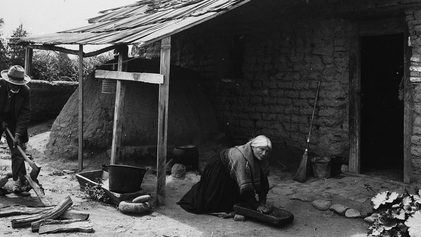 A Tongva man and woman work outside their home
