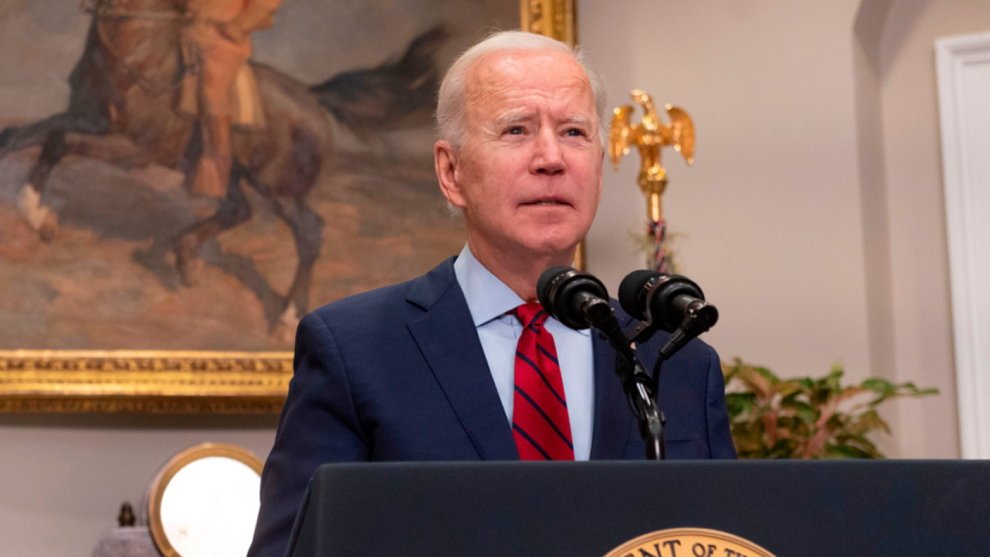 President Biden stands behind a lectern.