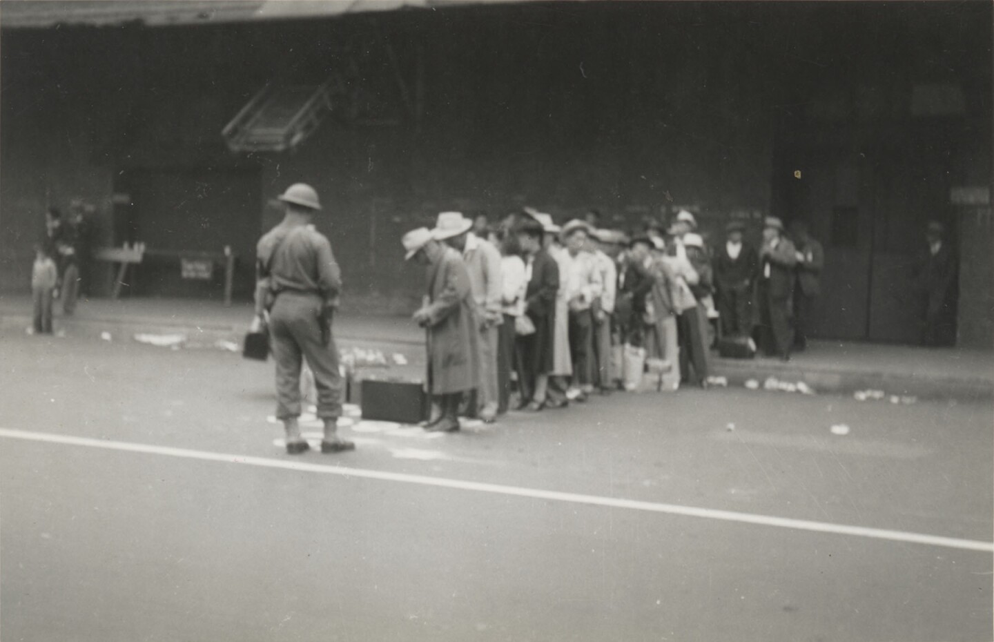 JANM-Japanese Americans lined up and under guard on central avenue.jpg