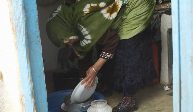 Khadija Ghouate washes dishes, a task that becomes increasingly difficult amid an extreme water shortage. | Earth Focus