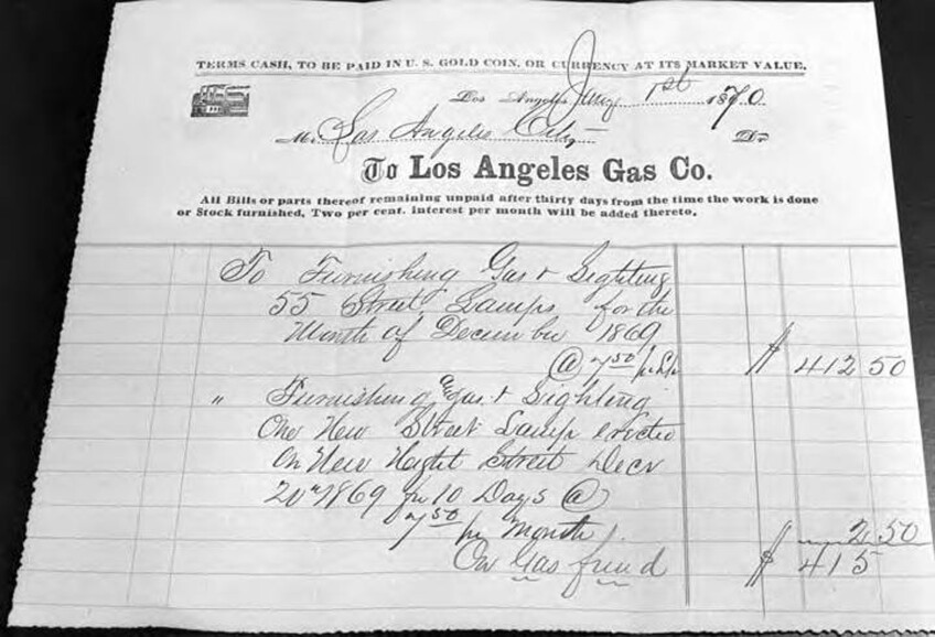 A photo of an electricity receipt. Across the top it reads: "Terms cash, to be paid in U.S. gold coin, or currency at its market value." In large, bold lettering it reads, "To Los Angles Gas Co." Below that, "All bills or parts thereof remaining unpaid after thirty days from the time the work is done or Stock furnished. Two per cent, interest per month will be added thereto." Two items are listed below on a grid, handwritten. The first item is listed as $412.50 and the second one $2.50. The total at the end indicates $415.