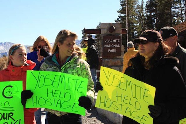 Occupy Yosemite organizer Stacey Powells, right, holds a sign next to Mammoth Lakes resident Jennifer DeAngelis. | Photo: Dan McConnell