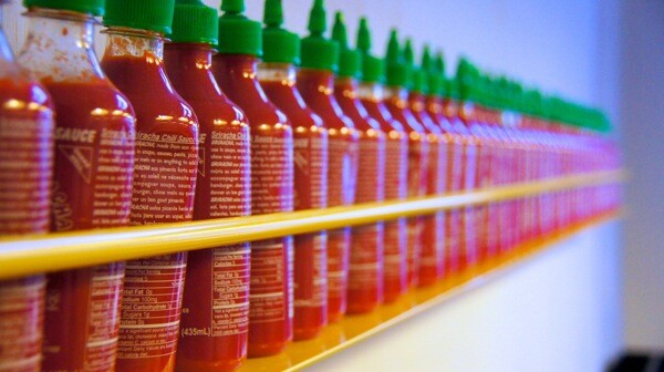 Sriracha bottles displayed at a restaurant.