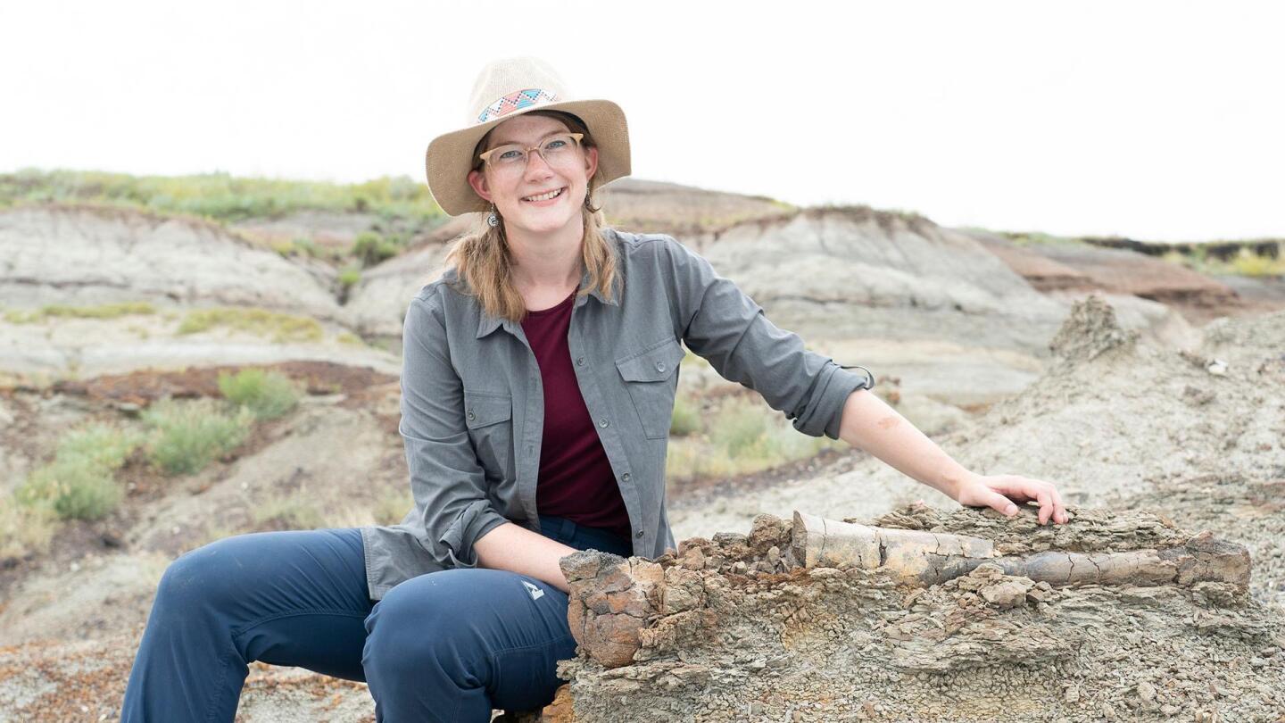 Emily Graslie poses for a photo on some rocks. | "Prehistoric Road Trip: We Dig Dinosaurs"