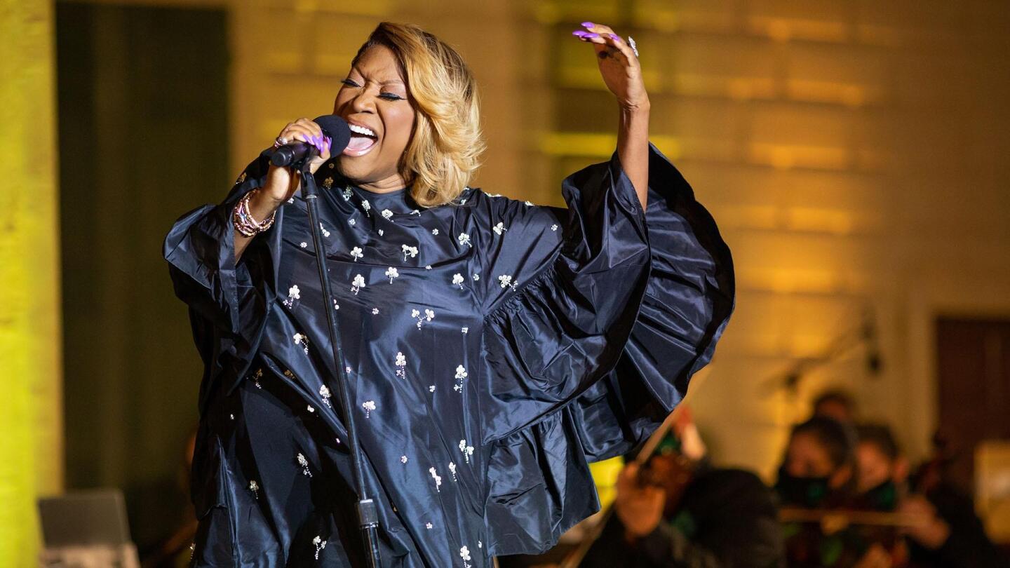A woman belts out in a song on stage. | From "United in Song: A Celebration of America's Resilience"