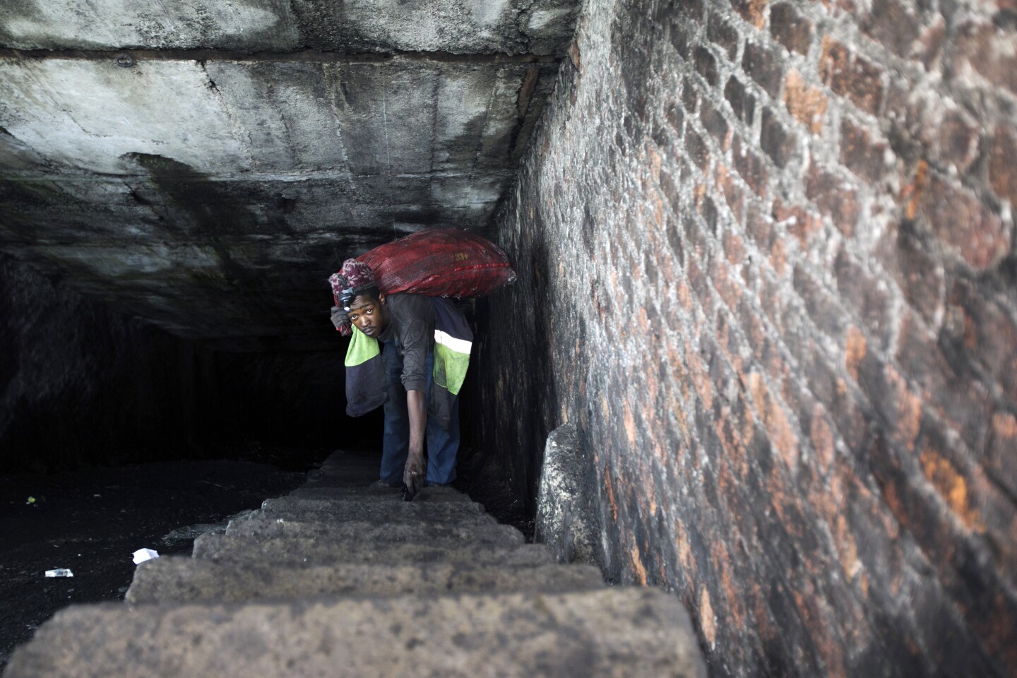 A man climbs stairs emerging from an abandoned coal mine. | Courtesy of of Thomson Reuters Foundation