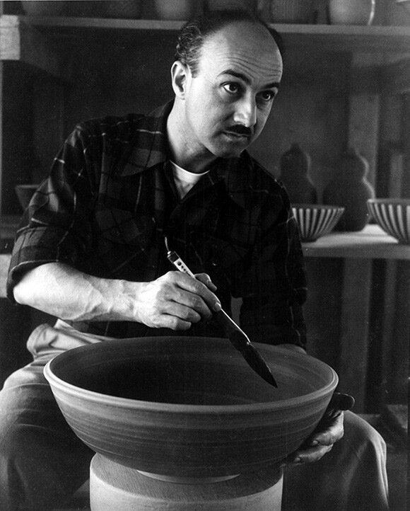 Harrison McIntosh applies brush work to a large bowl in his first studio, Foothill Blvd., Claremont, CA, c. 1953