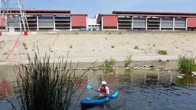 A man paddles in the L.A. River. | Sandi Hemmerlein