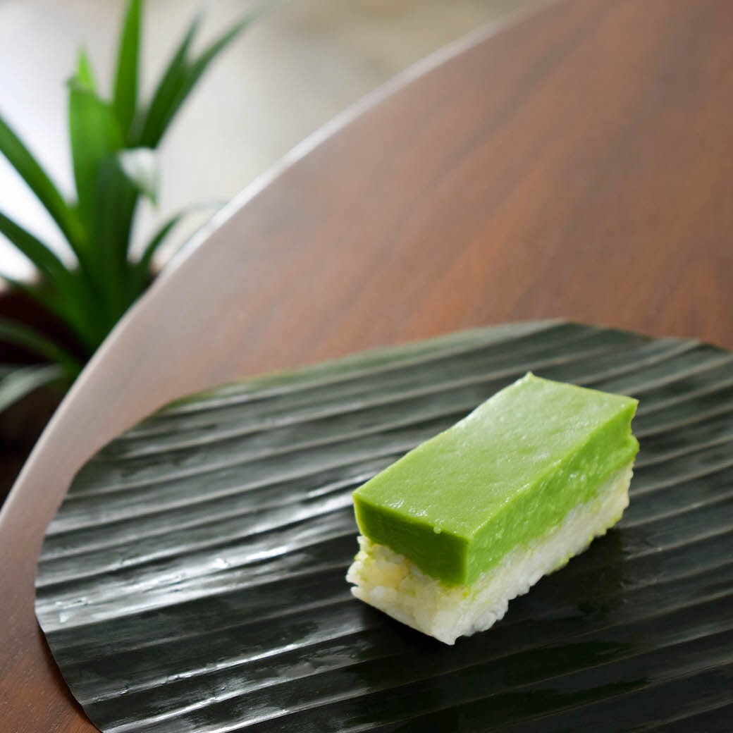 Kueh salat (a cousin of Teochew gue) is a popular Malaysian cake with pressed sticky rice layered with coconut egg custard flavored with pandan.
