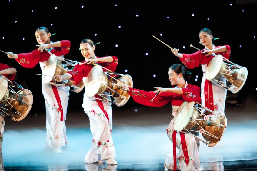 Women in traditional Korean wear with drums.
