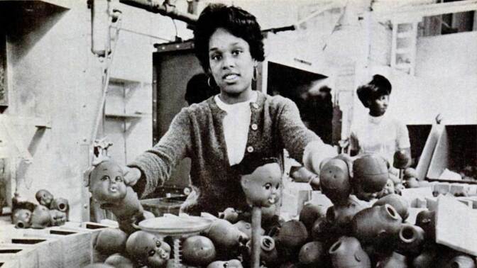 A woman manufacturing Shindana Toy dolls from a Jet Magazine story published by Johnson Publishing Company | Still from "Lost LA" Shindana Toys
