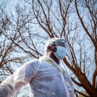 A Phlebotomist with the National Health Laboratory Service is pictured outside the Pudumong Healthcare Centre in the North West Province, South Africa, during a routine visit on September 4, 2020. | Thomson Reuters Foundation/Gulshan Khan