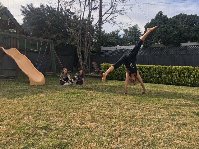 Kathleen Abing doing cartwheels outdoors.