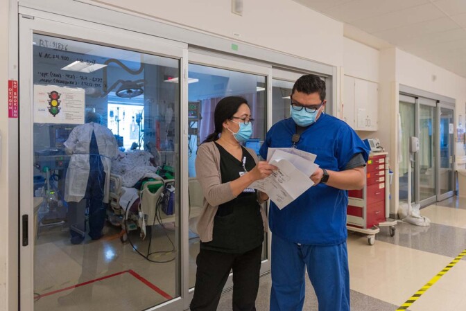 Nurse manager Lea Salinas and registered nurse Jonathan Magdaleno go over a patient’s record. | Heidi de Marco/California Healthline