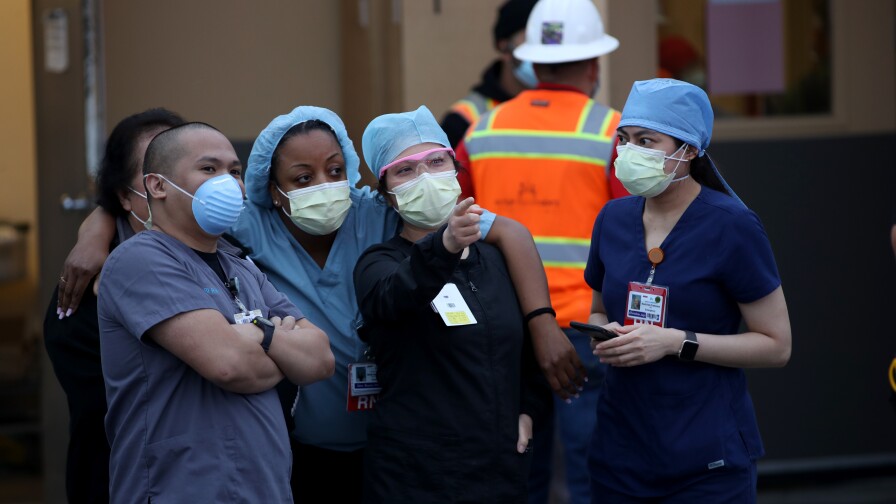 Nurses stand outside of Kaiser Hospital