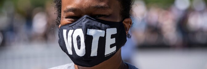 African American protester wearing a mask that says, "Vote" in Washington Square Park expressing the sentiment that voting in Nov. 2020 will be a way to help affect change in policies to end racial injustice. June 19, 2020. |Ira L. Black/Corbis via Getty
