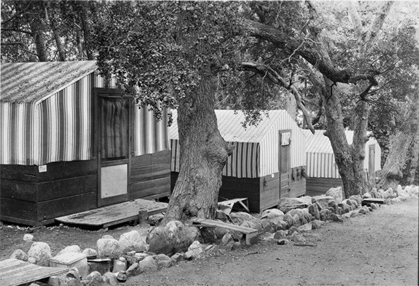 Housekeeping tents located along a running flume of water at Camp Baldy, ca.1930 | Digitally reproduced by the USC Digital Library; From the California Historical Society Collection at the University of Southern California