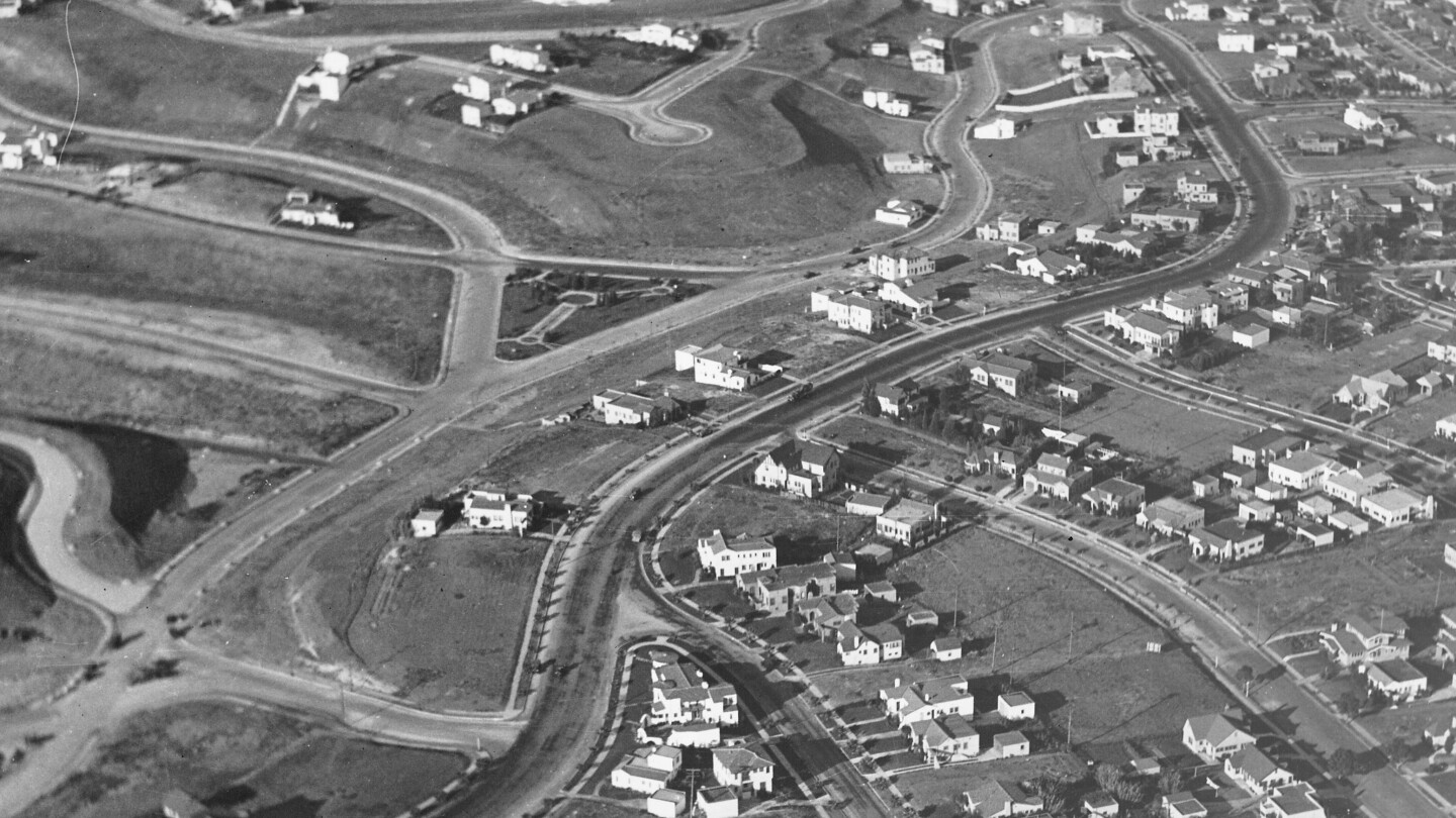 An aerial photo showing winding roads and homes laid out in an orderly fashion.