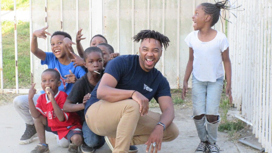 Bruce Lemon Jr. playing with youth during a rehearsal break of " A Jordan Downs Illumination."| Nancy Keystone