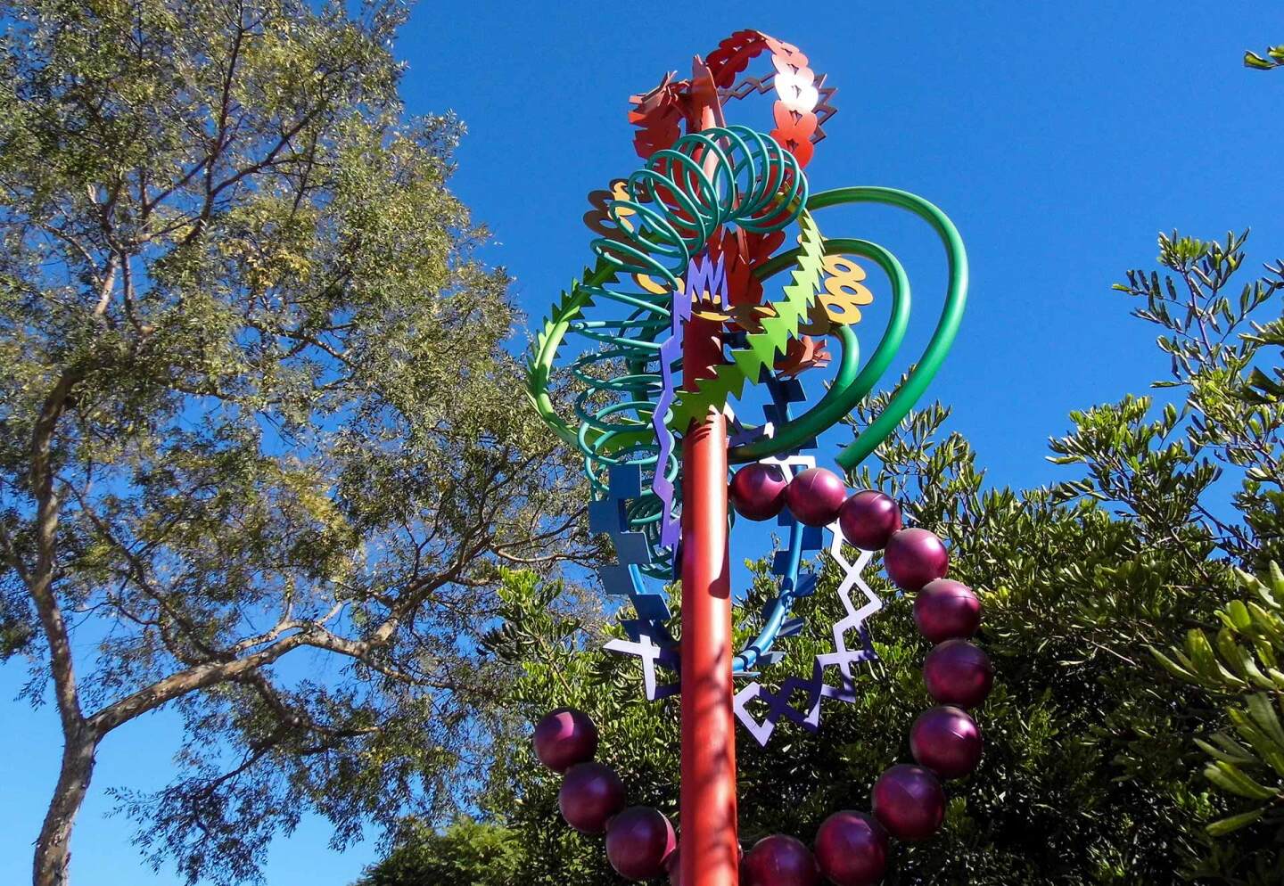 Nancy Mooslin's “West Hollywood Clock” sculpture rises 18 feet off the ground and simultaneously represents the 12 hours on a clock, 12 pitches in a musical octave, and 12 hues of a color wheel — all embodied in 12 different geometric shapes.