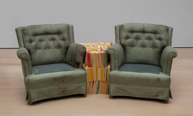 Rodney McMillian, “Chairs and Books,” 2004. Found armchair, found books. Dimensions variable. Hammer Museum, Los Angeles. Gift of Peter Norton. © 2004 Rodney McMillian. From the exhibition belonging. Hammer Museum, Los Angeles. | Jeff McLane