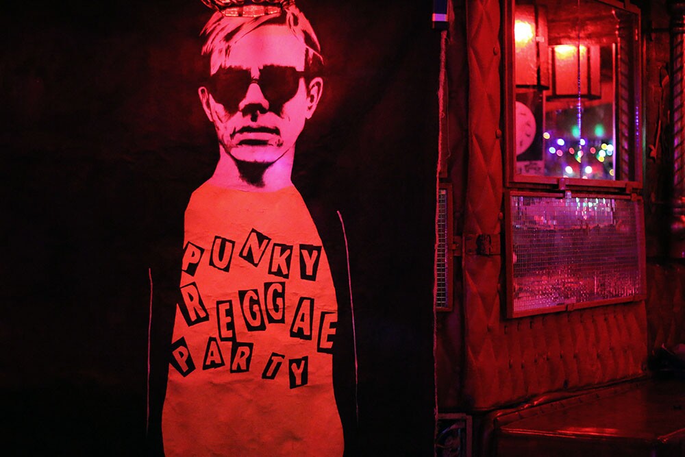 Poster of a man with sunglasses and a shirt reading "Punky Reggae Party."