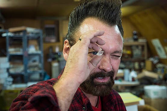 David examining a calcite specimen known for its polarizing characteristics. | Photo © Kim Stringfellow.