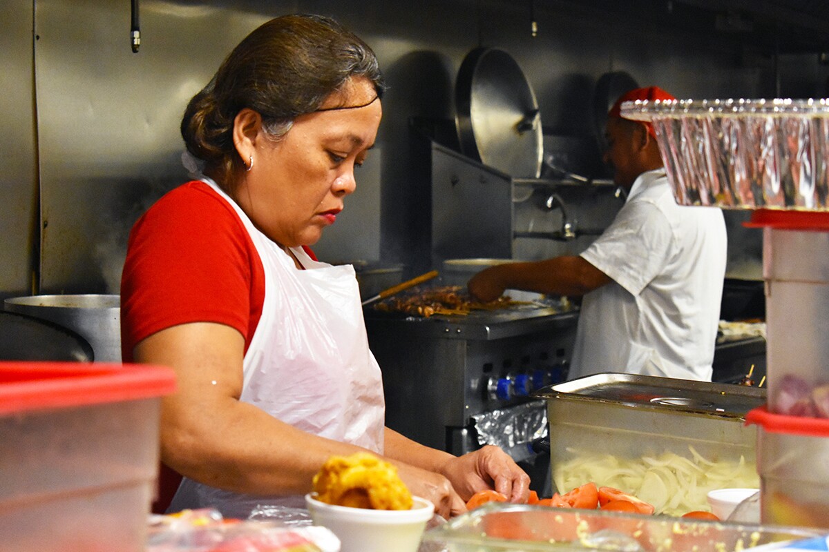 A worker does food preparation in Arko Foods Market's turo-turo section. | Jacqueline Lee