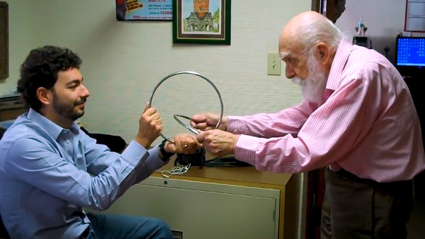 James Randi performs a magic trick on Massimo Polidoro.