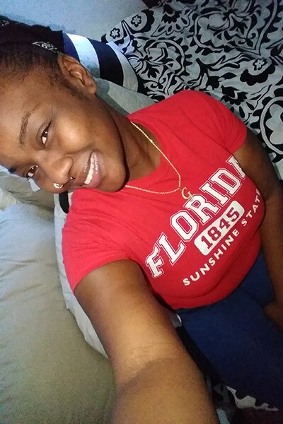 person takes a selfie while wearing a red t-shirt. 