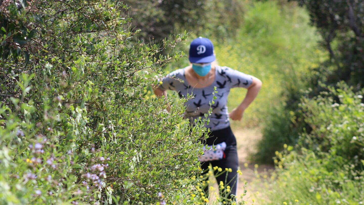 A woman stops on a trail in Temescal Canyon, May 9. 2020, the first day L.A. City and County trails are reopened. | Karen Foshay