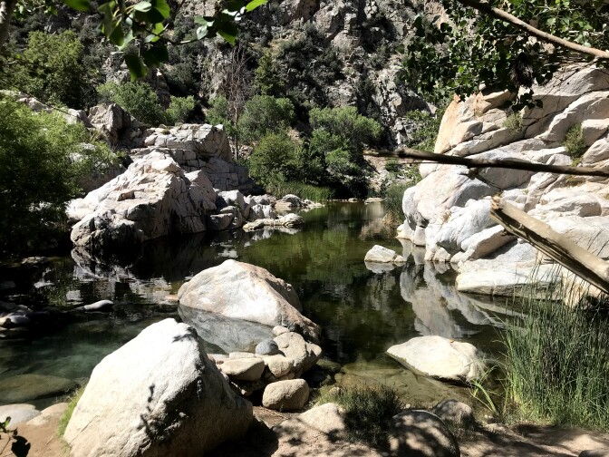 A natural spring surrounded by large rocks.