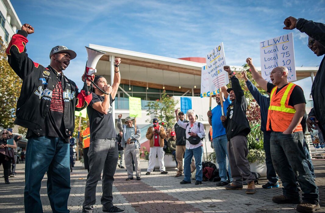 Organizers raise their fist at a union rally in Oakland. | Brooke Anderson