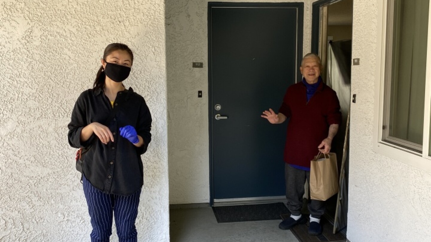 A volunteer delivered a supply bag under social distancing guidelines. | Sophat Phea/CCED Organizer via LAist