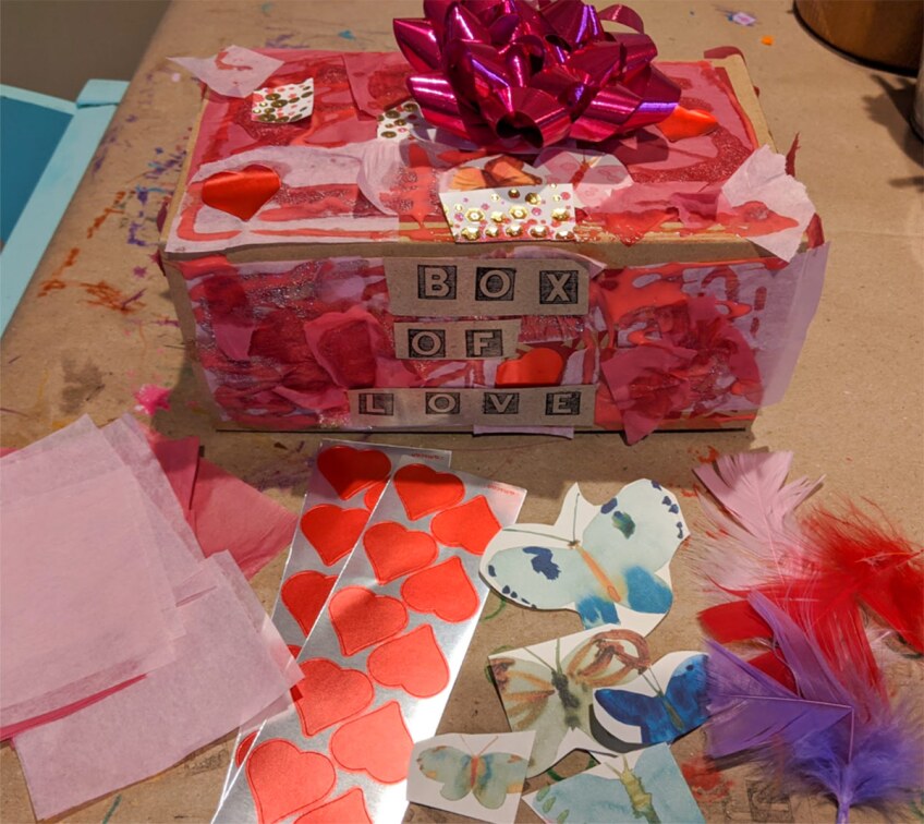 a highly decorated box with a bow and the words "box of love" on it