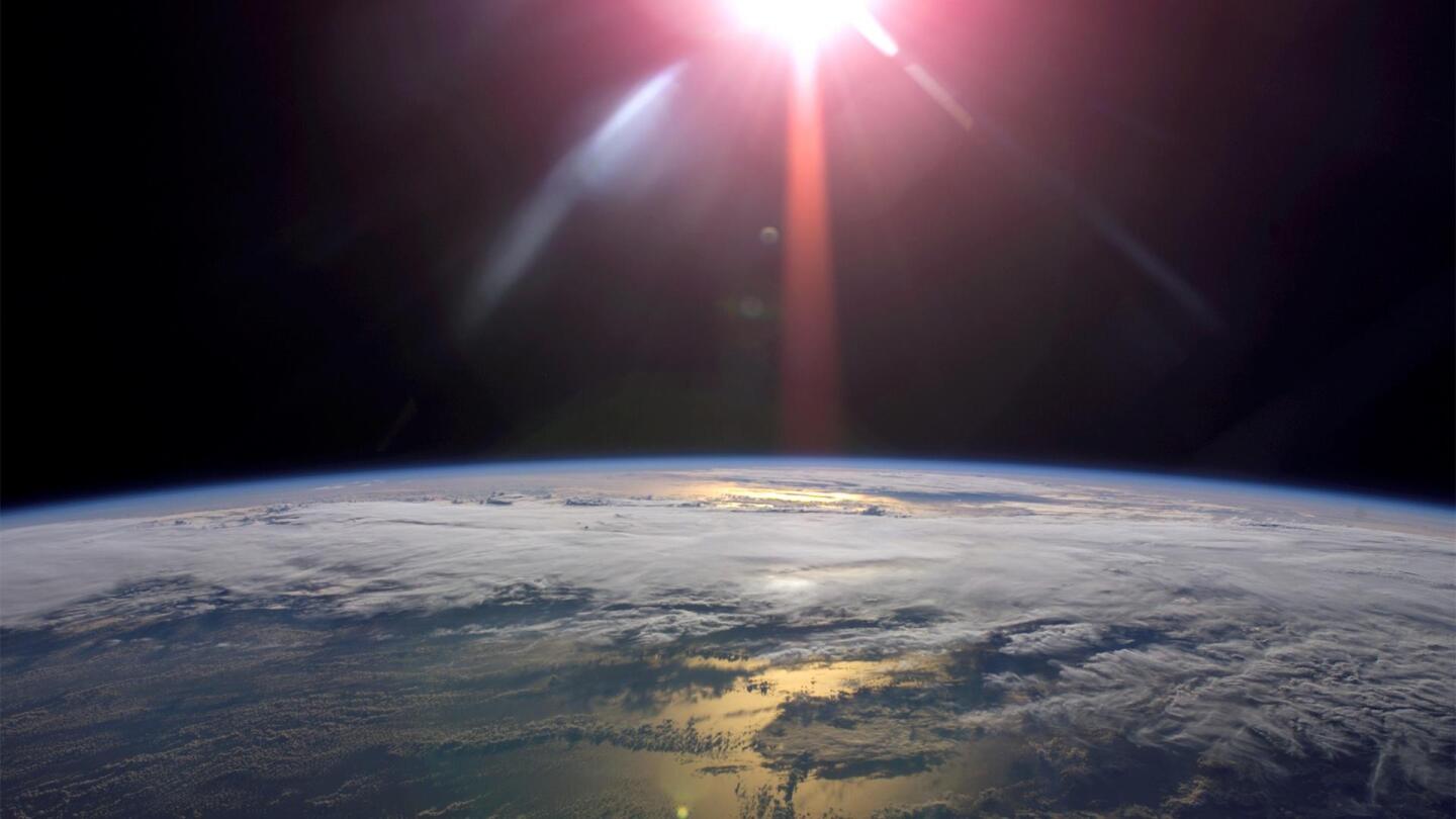 The sun from outer space shines down on Earth. | From "NOVA: Can We Cool the Planet?"