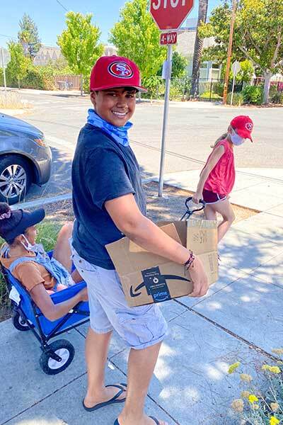 Aila Malik’s children gather items for a food drive they organized.