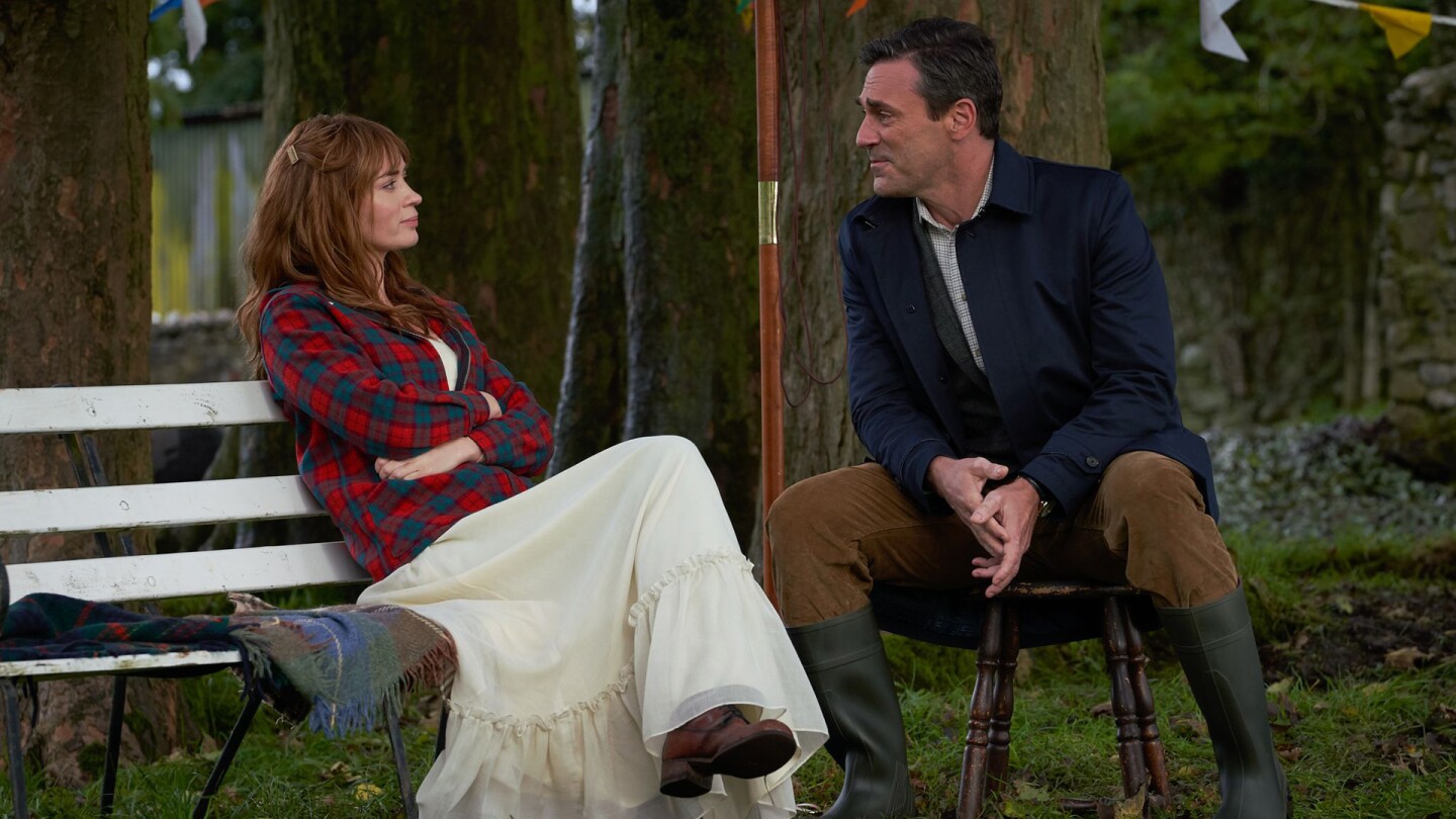 A woman sitting on a bench and a man sitting on a stool look at each other. | From "Wild Mountain Thyme"