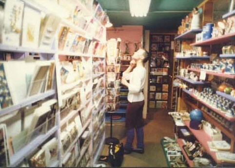 Inside the WACKO/Soap Plant store on Melrose. The walls are a vibrant pink color while the ceiling is green. Various knick-knacks, books and cards line the walls on shelves.