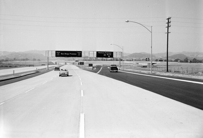 The concrete practically glistens in this 1958 photograph of the San Diego Freeway (then CA-7, now I-405), looking south at its junction with the Ventura Freeway, courtesy of the Los Angeles Examiner collection, USC Libraries