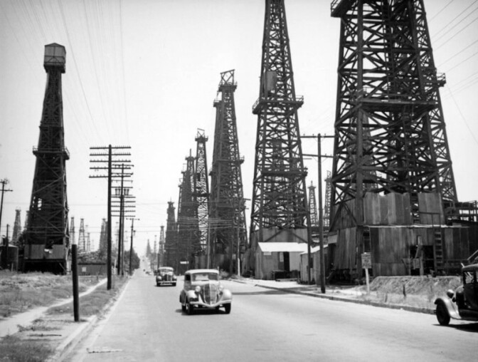 Driving through a forest of derricks in Signal Hill. Circa 1937 photo by Herman Schultheis, courtesy of the Photo Collection - Los Angeles Public Library.