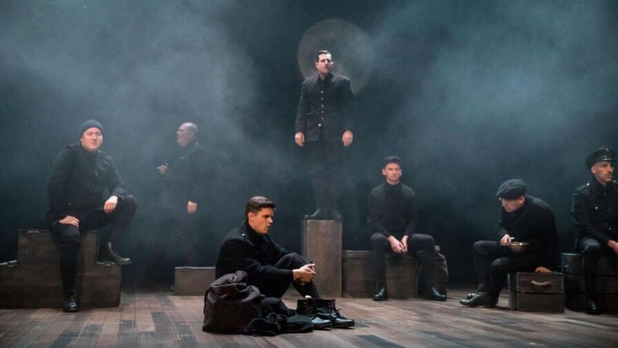 Stage performers pose in the middle of a musical number.