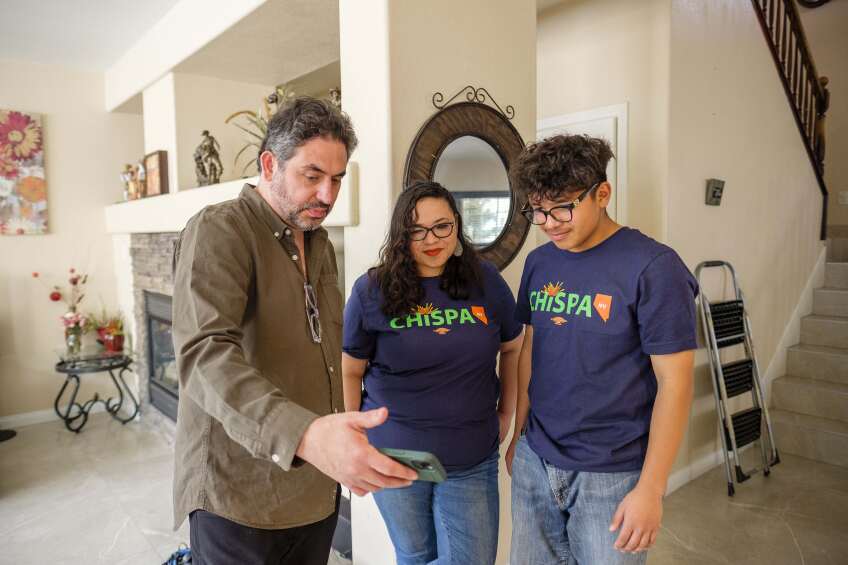 In 2024, Director/Producer Bernardo Ruiz shows Audrey Peral and son Francisco photos of them from 2020 Photo credit: Roberto (Bear) Guerra