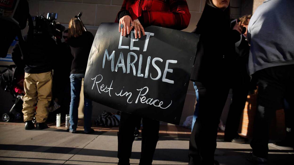 Still of protester holding sign from "62 Days." | Reel South